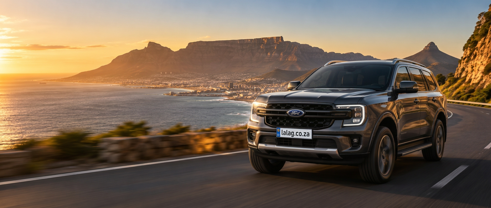 Ford SUV driving along a Cape Town coastal road with Table Mountain behind it